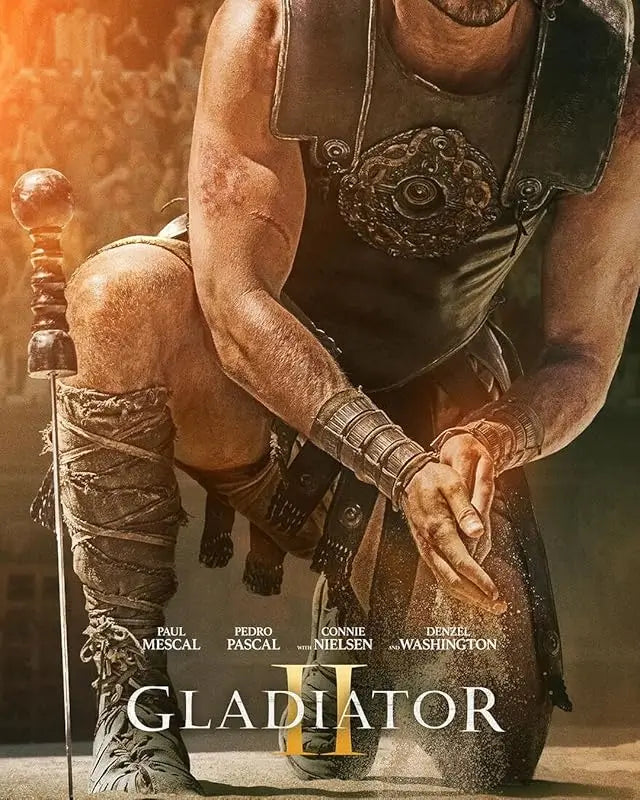 Gladiator II 2024 movie poster showing Lucius standing in the Colosseum amid roaring crowds, Roman soldiers, and dust-filled arena light, echoing the epic scale of ancient Rome.